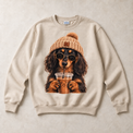 Sand Gildan crewneck sweatshirt with Long Haired Dachshund Iced Coffee graphic, front flat lay