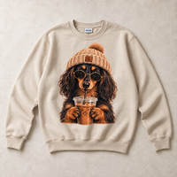 Sand Gildan crewneck sweatshirt with Long Haired Dachshund Iced Coffee graphic, front flat lay