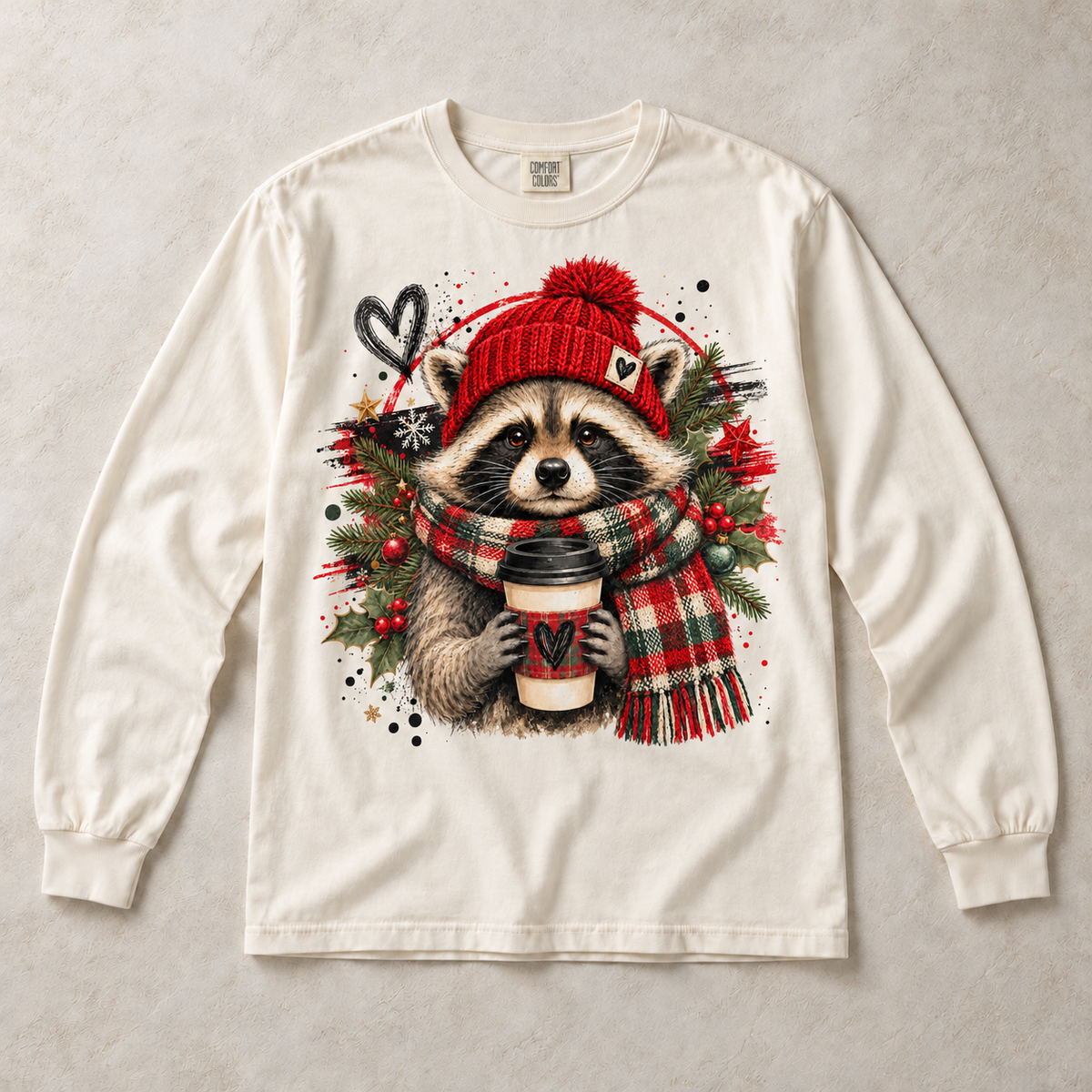 Ivory Comfort Colors long-sleeve T-shirt with Christmas Raccoon Coffee graphic, front flat lay