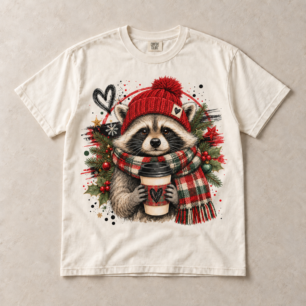 Ivory Comfort Colors short-sleeve T-shirt with Christmas Raccoon Coffee graphic, front flat lay