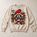 Sand Gildan crewneck sweatshirt with Christmas Raccoon Coffee graphic, front flat lay