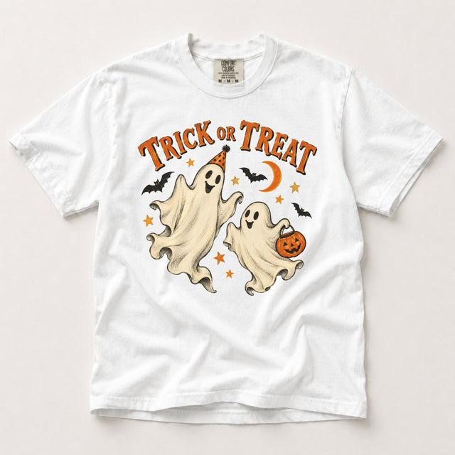 White Comfort Colors Trick or Treat Halloween shirt featuring two smiling cream ghosts, orange lettering, bats, a crescent moon and a pumpkin candy bucket