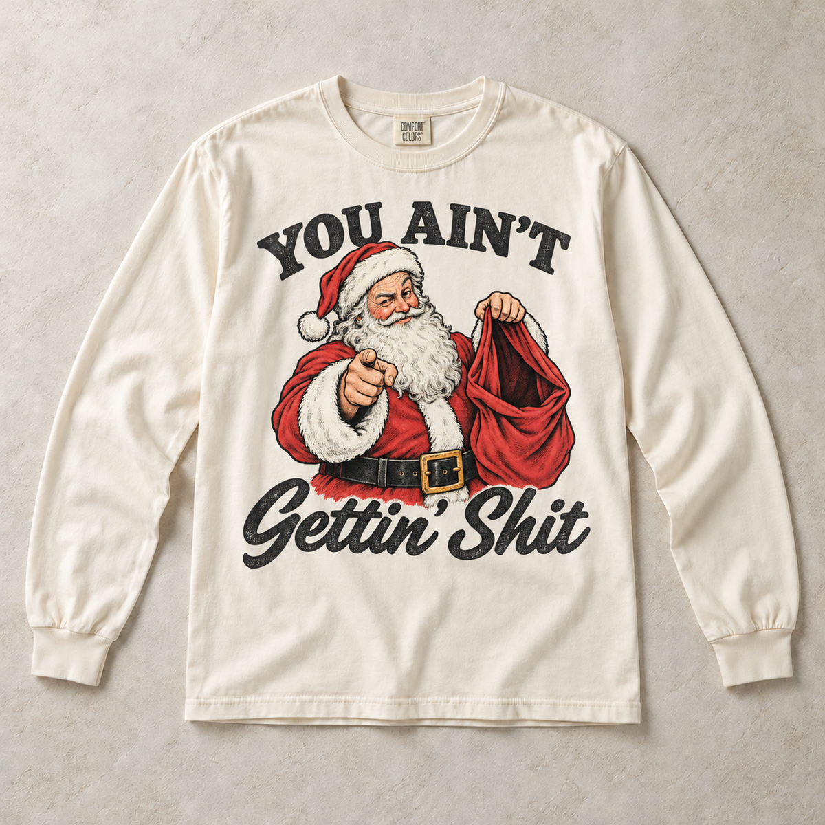 Ivory Comfort Colors long-sleeve T-shirt with You Ain't Gettin' Shit Funny Santa Christmas graphic, front flat lay