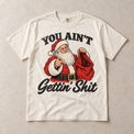 Ivory Comfort Colors short-sleeve T-shirt with You Ain't Gettin' Shit Funny Santa Christmas graphic, front flat lay