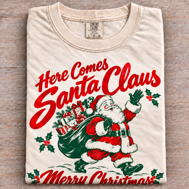 Natural Comfort Colors Here Comes Santa Claus vintage Christmas shirt folded on wood