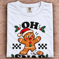 White Comfort Colors Oh Snap Gingerbread Shirt folded on wood