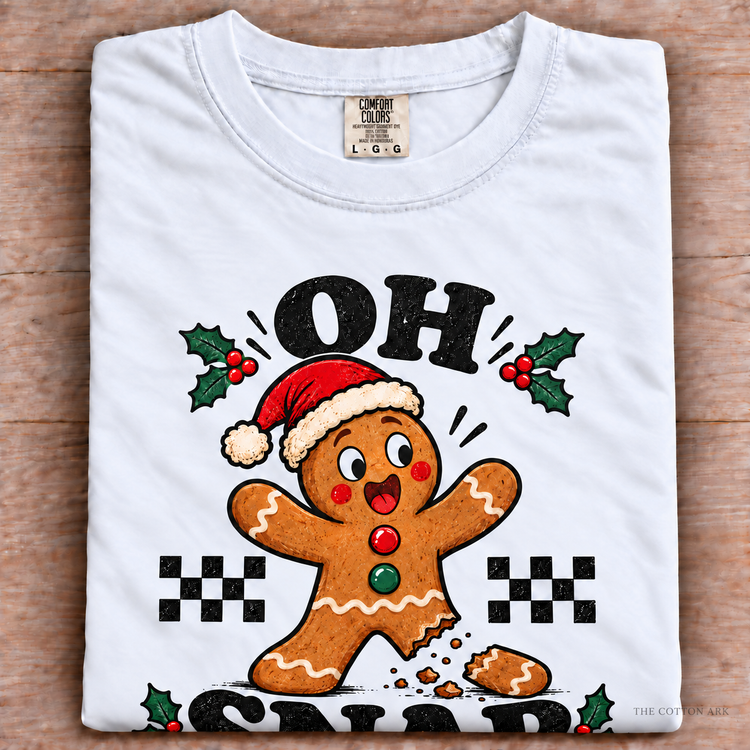 White Comfort Colors Oh Snap Gingerbread Shirt folded on wood
