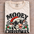 Natural Comfort Colors Mooey Christmas Shirt folded on wood