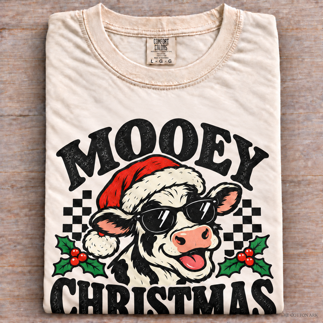 Natural Comfort Colors Mooey Christmas Shirt folded on wood