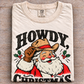 Natural Comfort Colors Howdy Christmas Shirt folded on wood