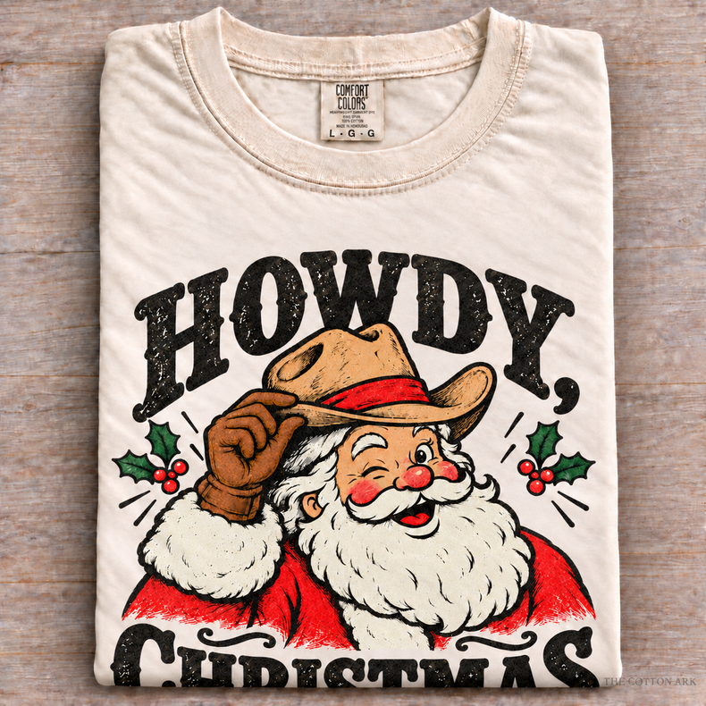Natural Comfort Colors Howdy Christmas Shirt folded on wood