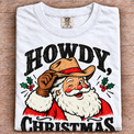 White Comfort Colors Howdy Christmas Shirt folded on wood