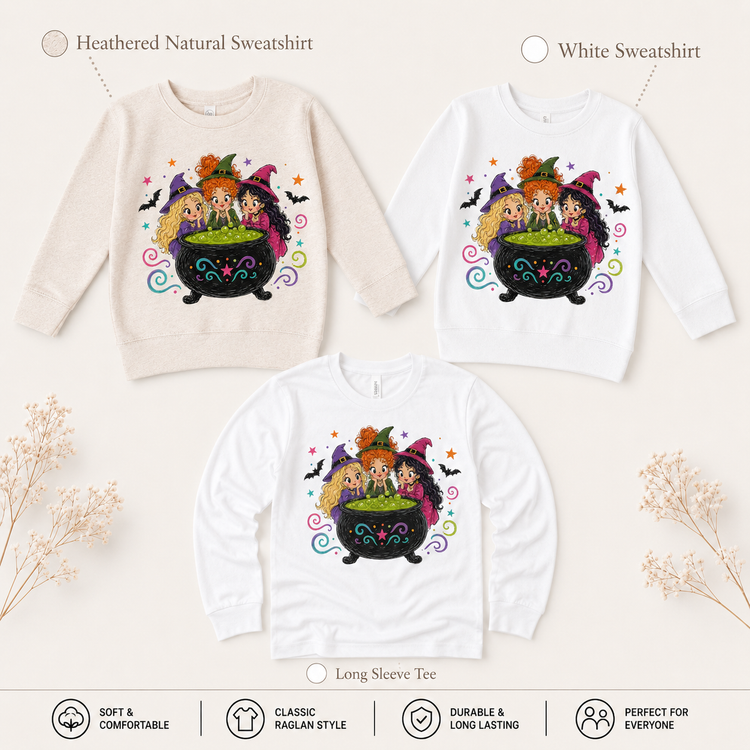 Natural and white sweatshirts and a white long-sleeve shirt featuring three witches around a bubbling cauldron with bats and stars.