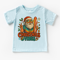 Christmas Vibes Surfing Santa design on a blue garment.