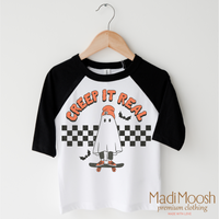 Creep It Real design on a black-accented shirt.