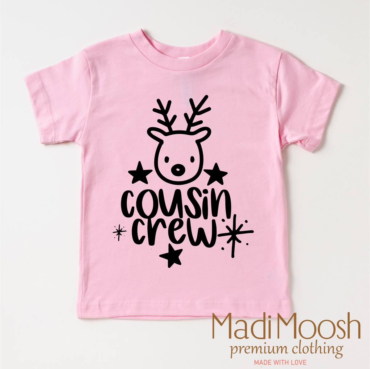 Cousin Crew Christmas design on a pink garment.