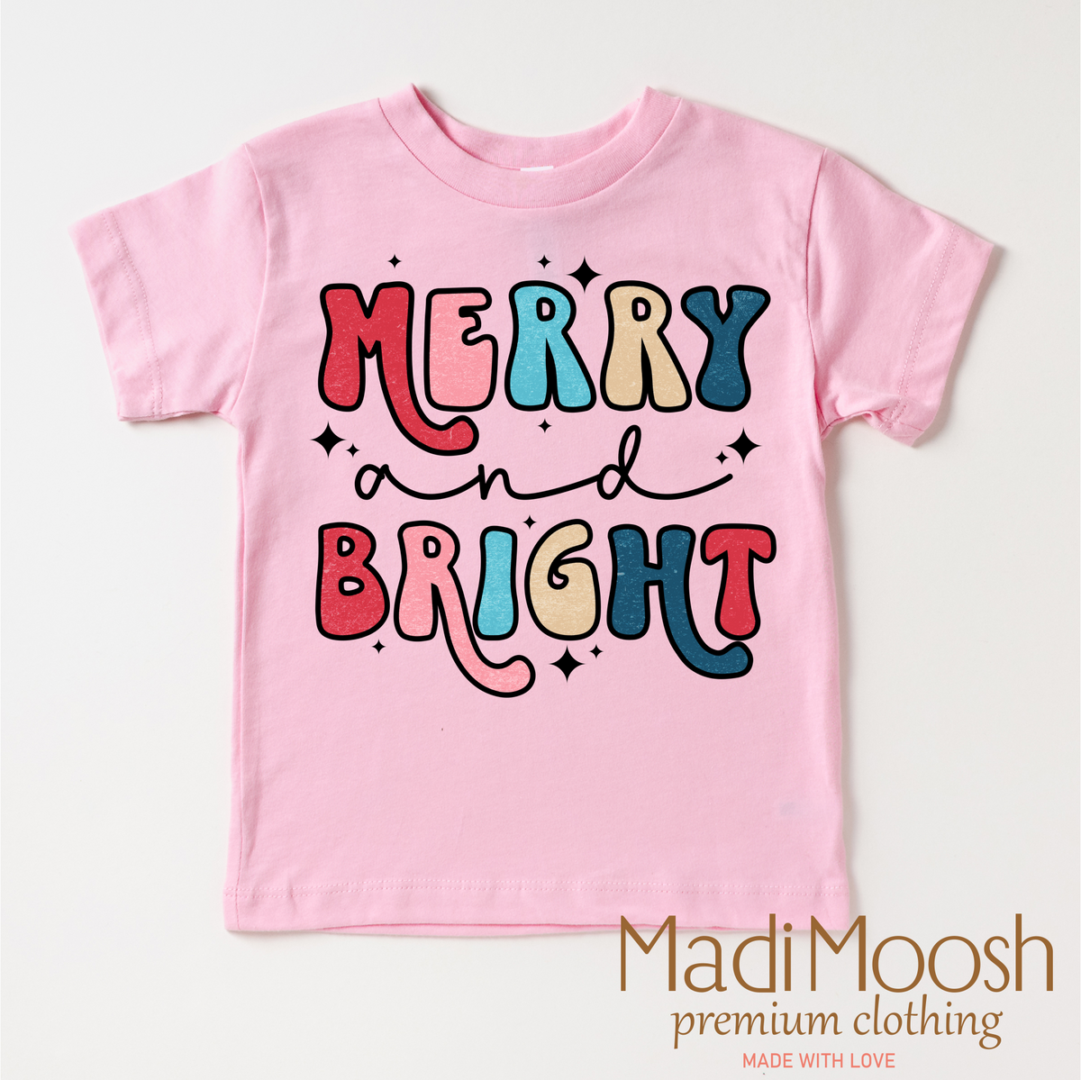 Merry And Bright Christmas design on a pink garment.