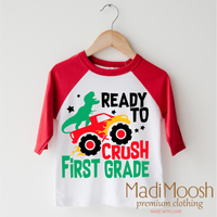 I'm Ready To Crush 1st Grade Dinosaur Monster Truck design on a red-accented shirt.