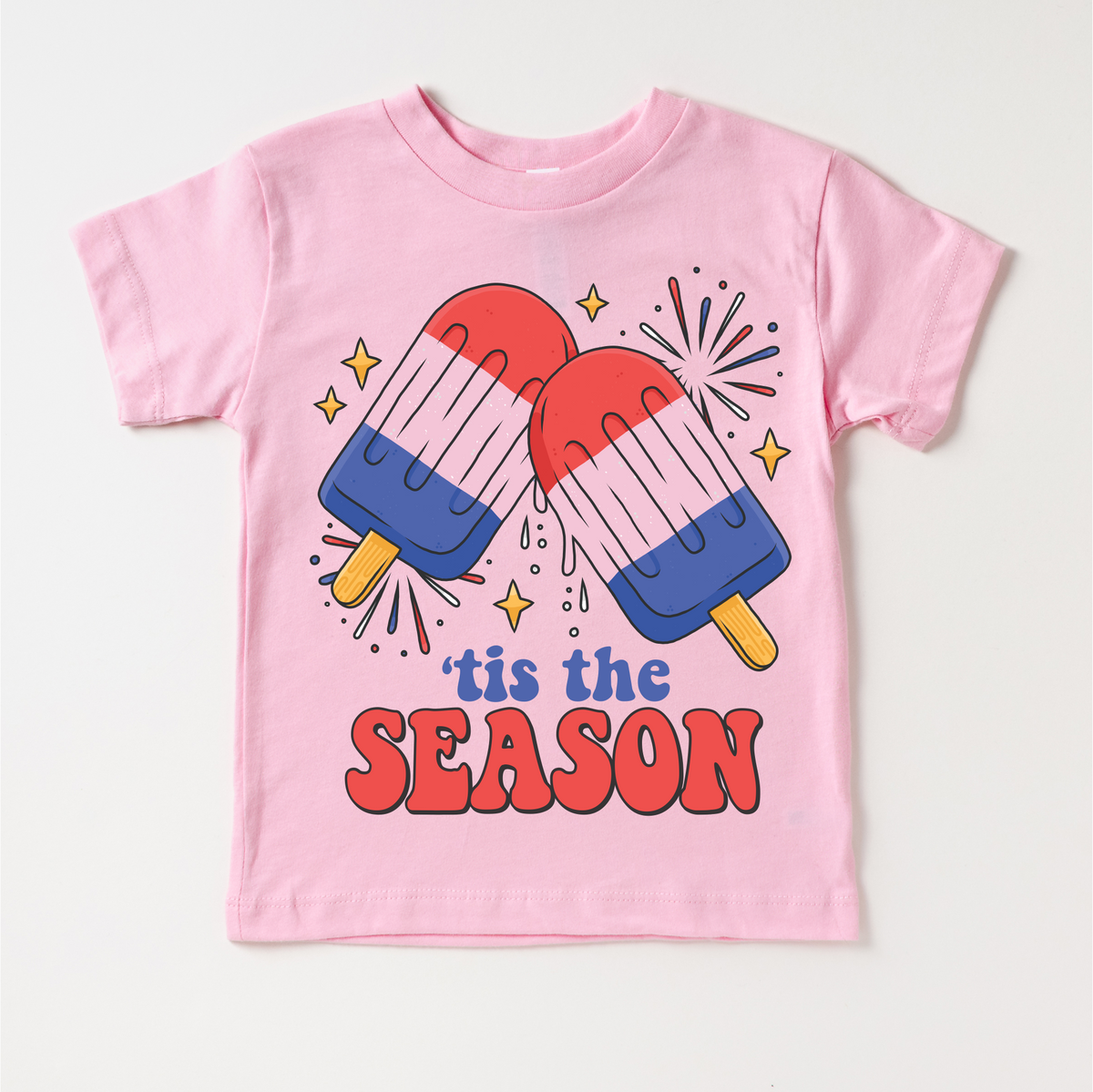Tis The Season 4th Of July design on a pink garment.