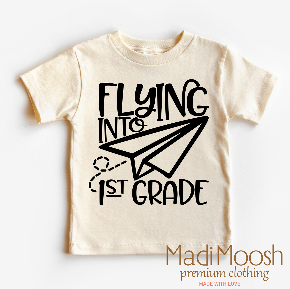 Flying Into First Grade Back To School design on a natural garment.