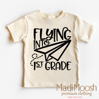 Flying Into First Grade Back To School design on a natural garment.