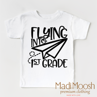 Flying Into First Grade Back To School design on a white garment.