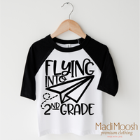 Flying Into 2nd Grade Back To School design on a black-accented shirt.