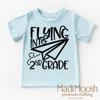 Flying Into 2nd Grade Back To School design on a blue garment.