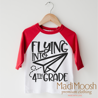 Flying Into 4th Grade Back To School design on a red-accented shirt.
