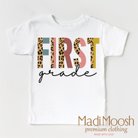 First Grade Leopard design on a white short sleeve T-shirt.