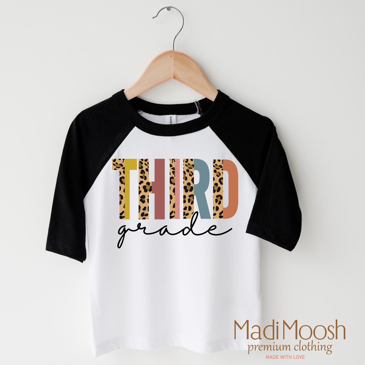 Third Grade Leopard design on a raglan shirt with black sleeves.