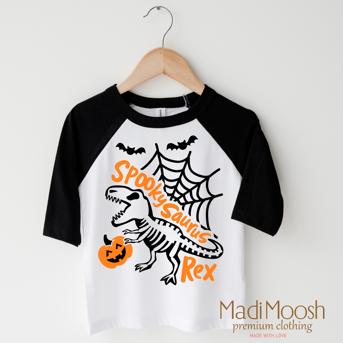 Spookysauras Dinosaur design on a raglan shirt with black sleeves.