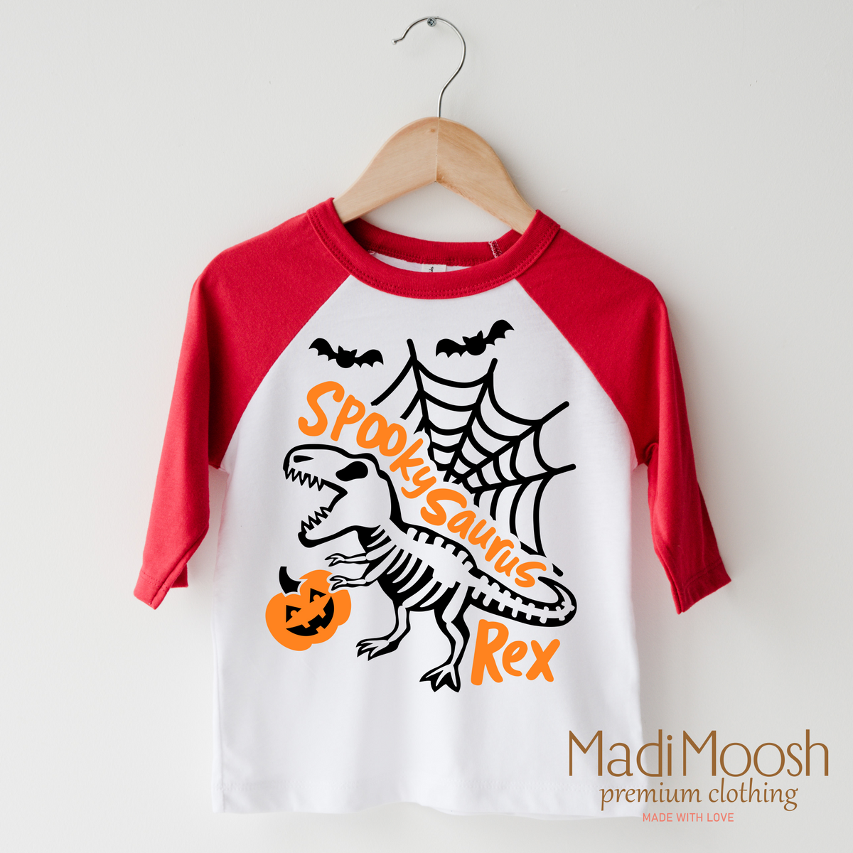Spookysauras Dinosaur design on a raglan shirt with red sleeves.
