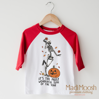 It's The Most Wonderful Time Of The Year design on a raglan shirt with red sleeves.