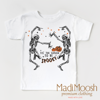 Tis The Season To Be Spooky design on a white short sleeve T-shirt.