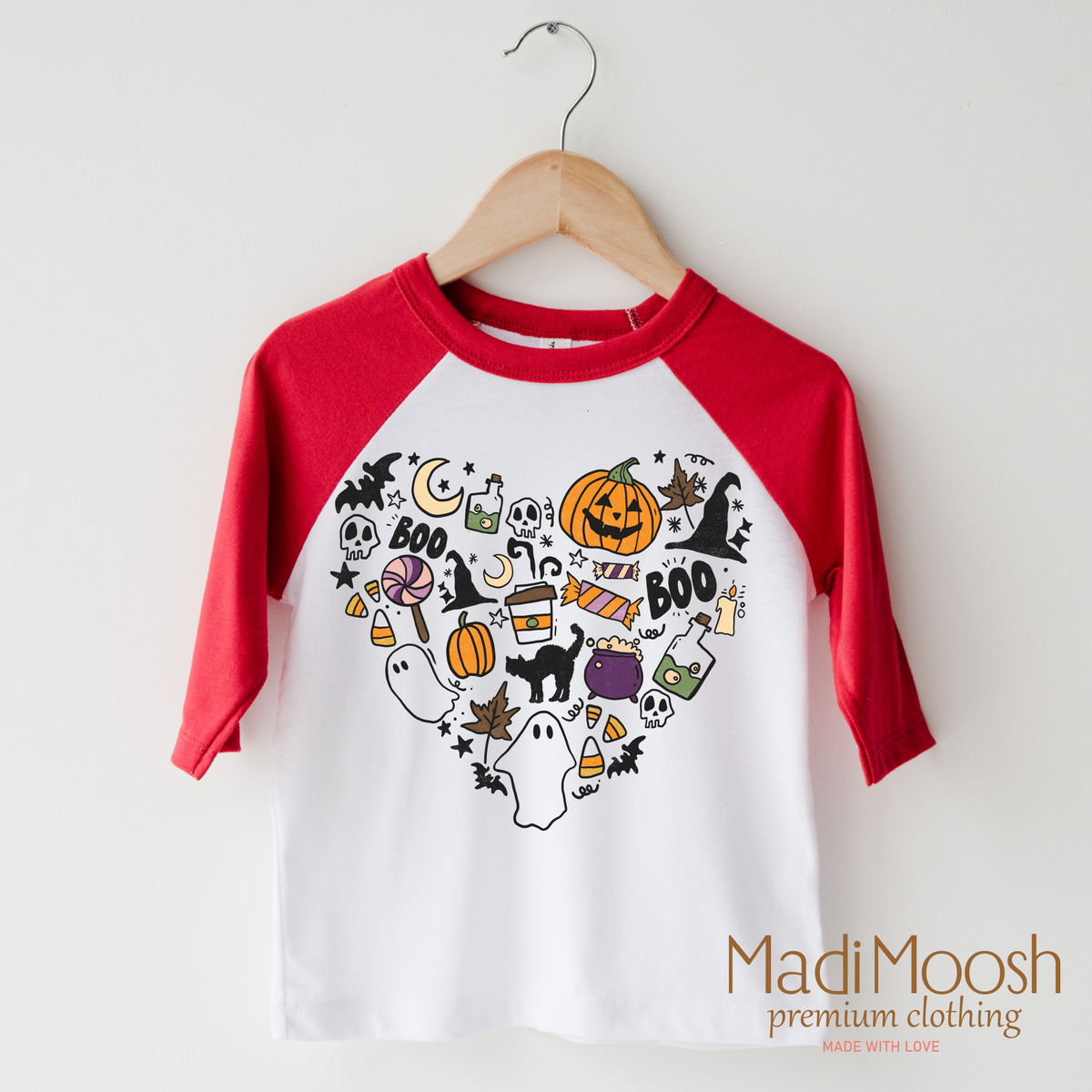 I Love Halloween Heart design on a raglan shirt with red sleeves.