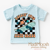 Rollin' Into 5th Back To School design on a blue garment.