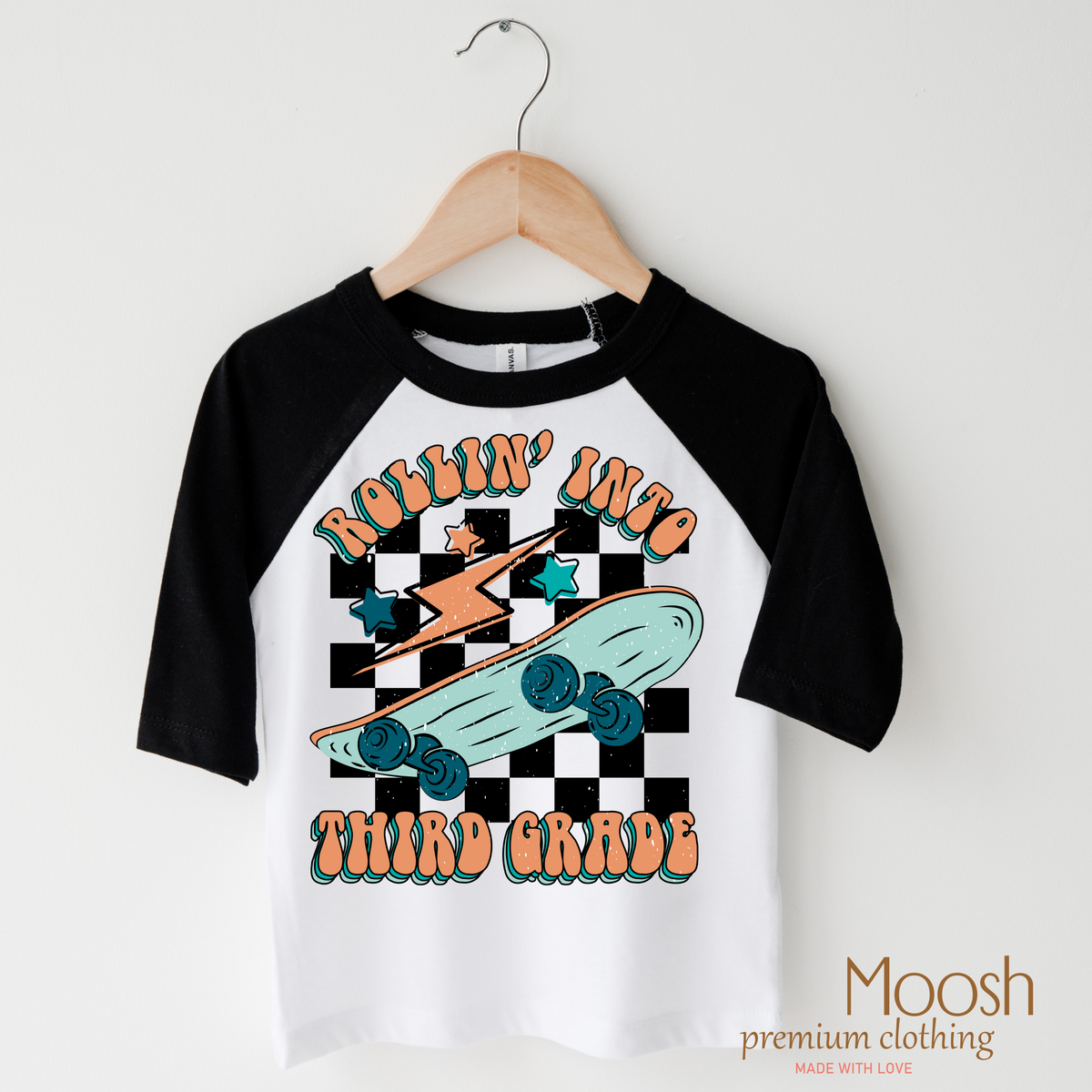 Rollin' Into 3rd Back To School design on a raglan shirt with black sleeves.