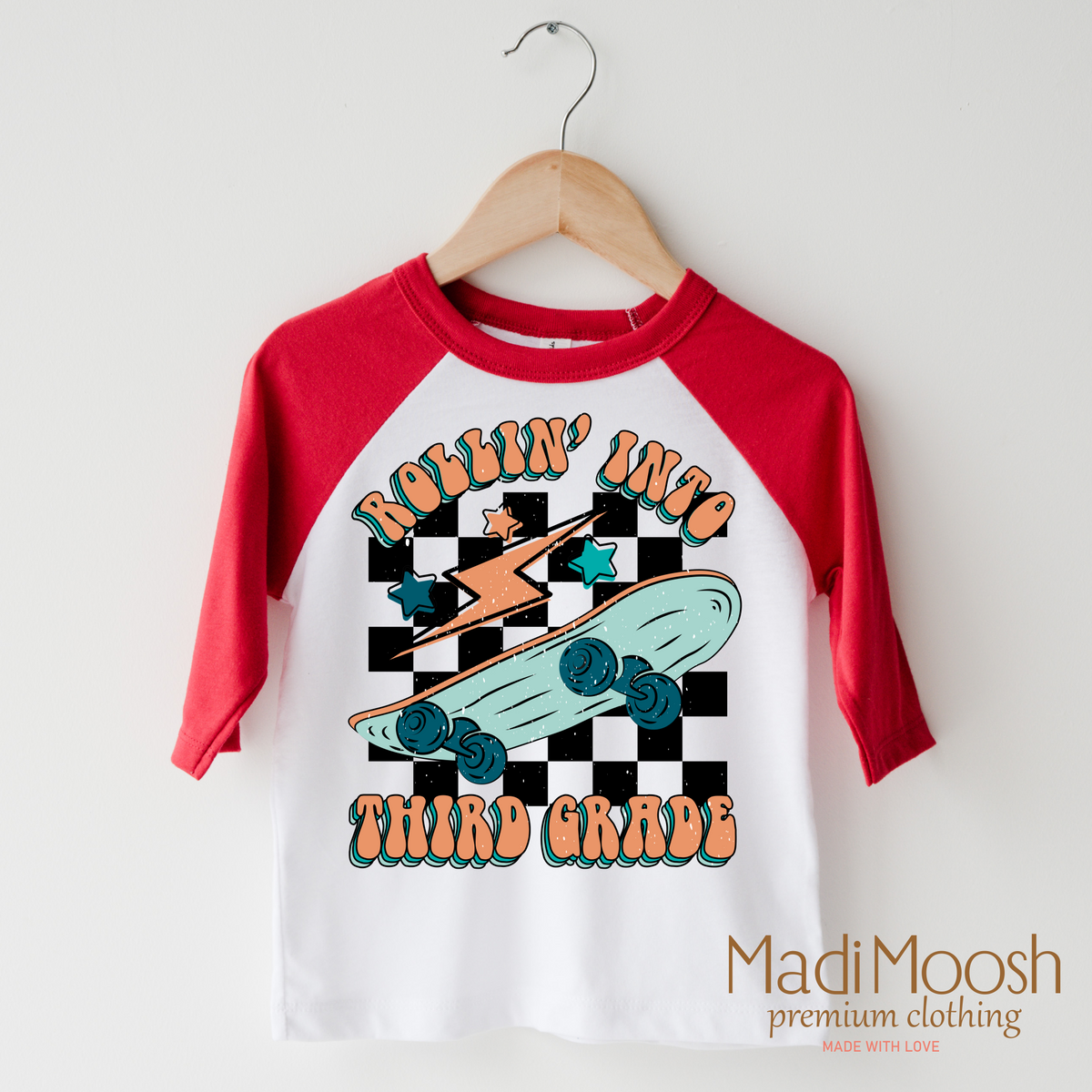 Rollin' Into 3rd Back To School design on a raglan shirt with red sleeves.