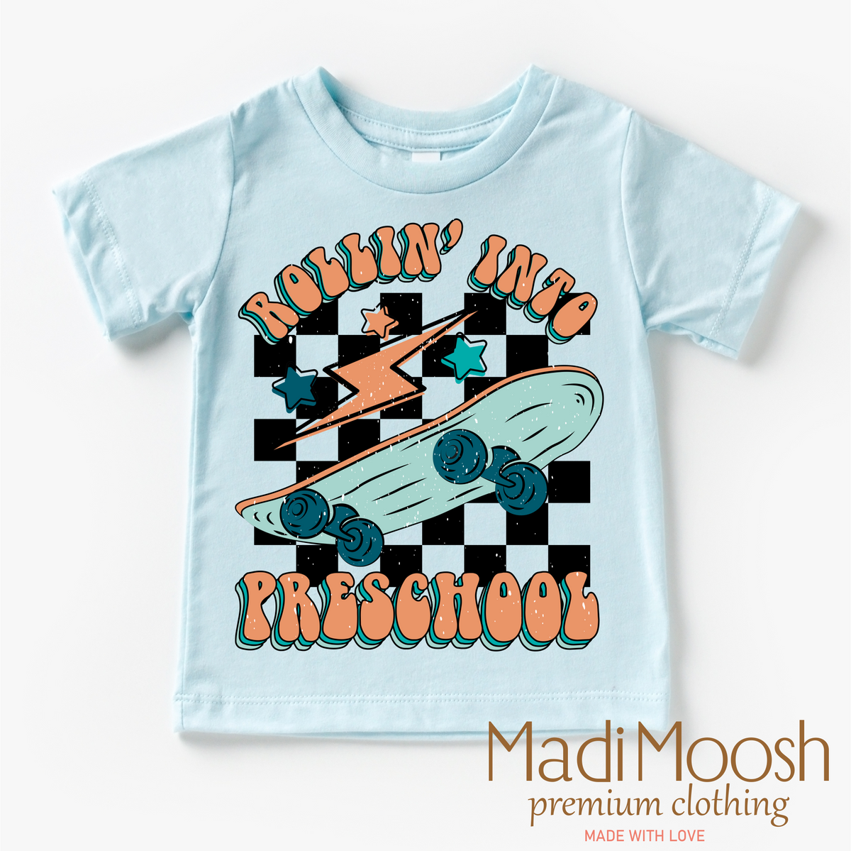 Rollin' Into Preschool Back To School design on a blue garment.