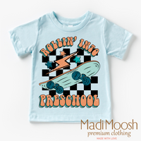 Rollin' Into Preschool Back To School design on a blue garment.