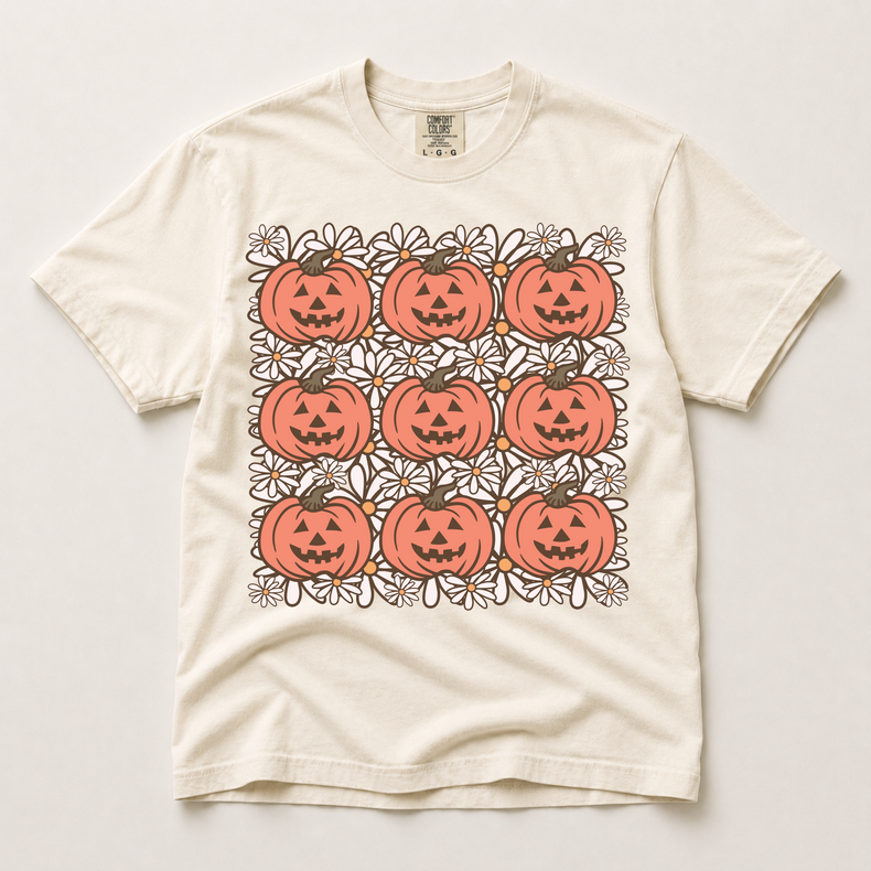 Retro jack-o'-lantern and daisy grid graphic on an ivory Comfort Colors T-shirt