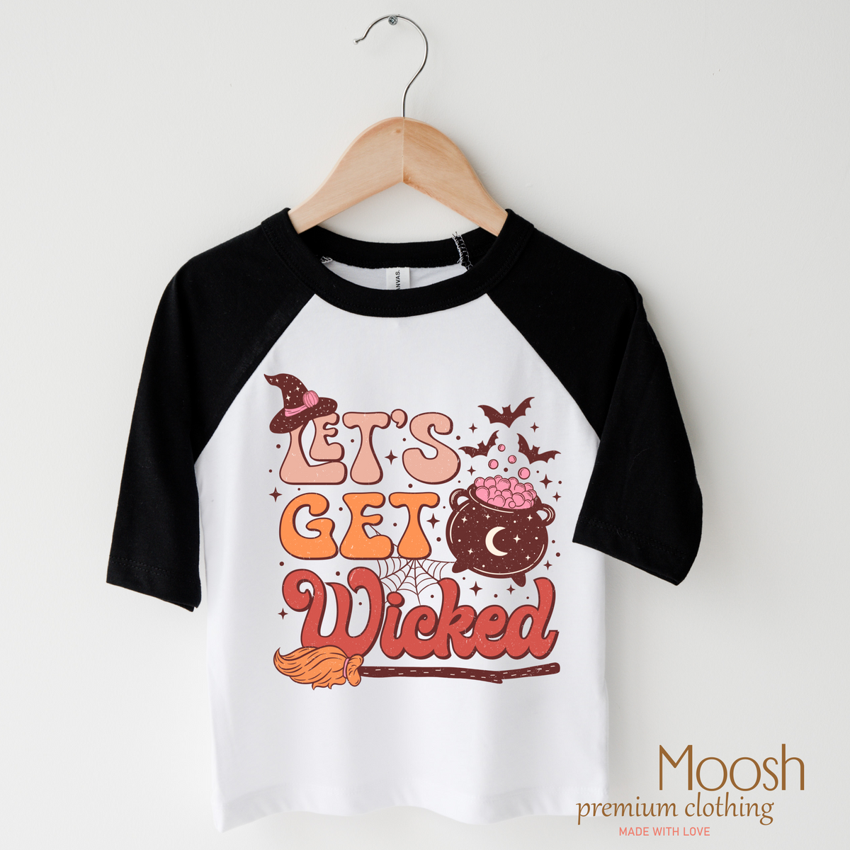 Let's Get Wicked Witch design on a raglan shirt with black sleeves.