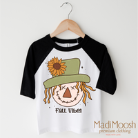 Fall Vibes Scarecrow design on a black-accented shirt.