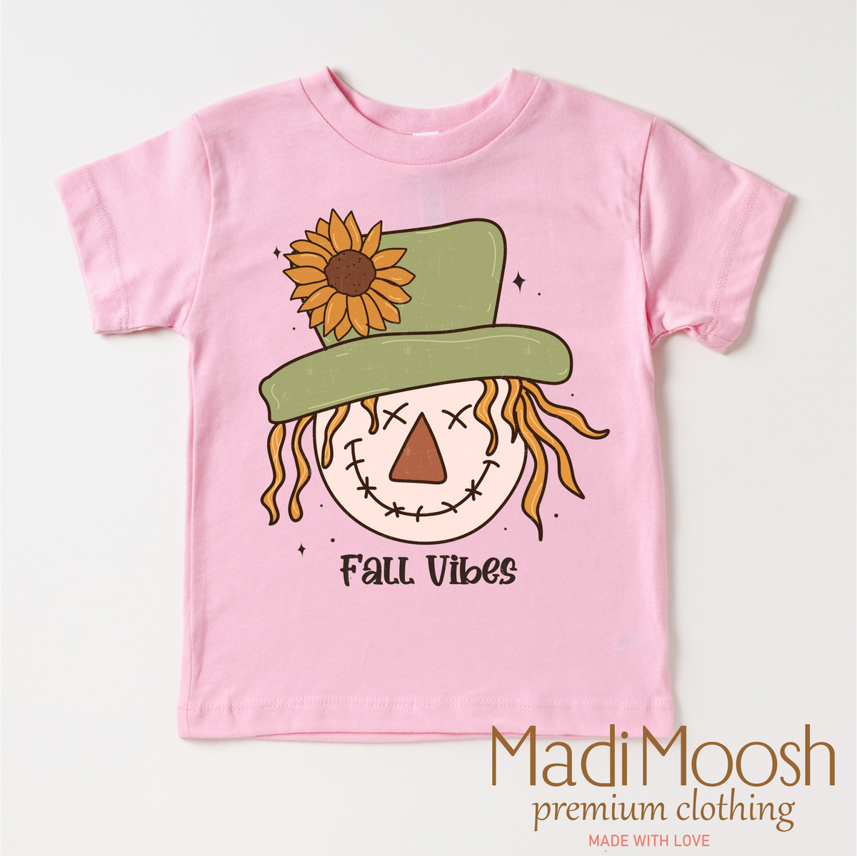 Fall Vibes Scarecrow design on a pink garment.