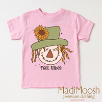 Fall Vibes Scarecrow design on a pink garment.