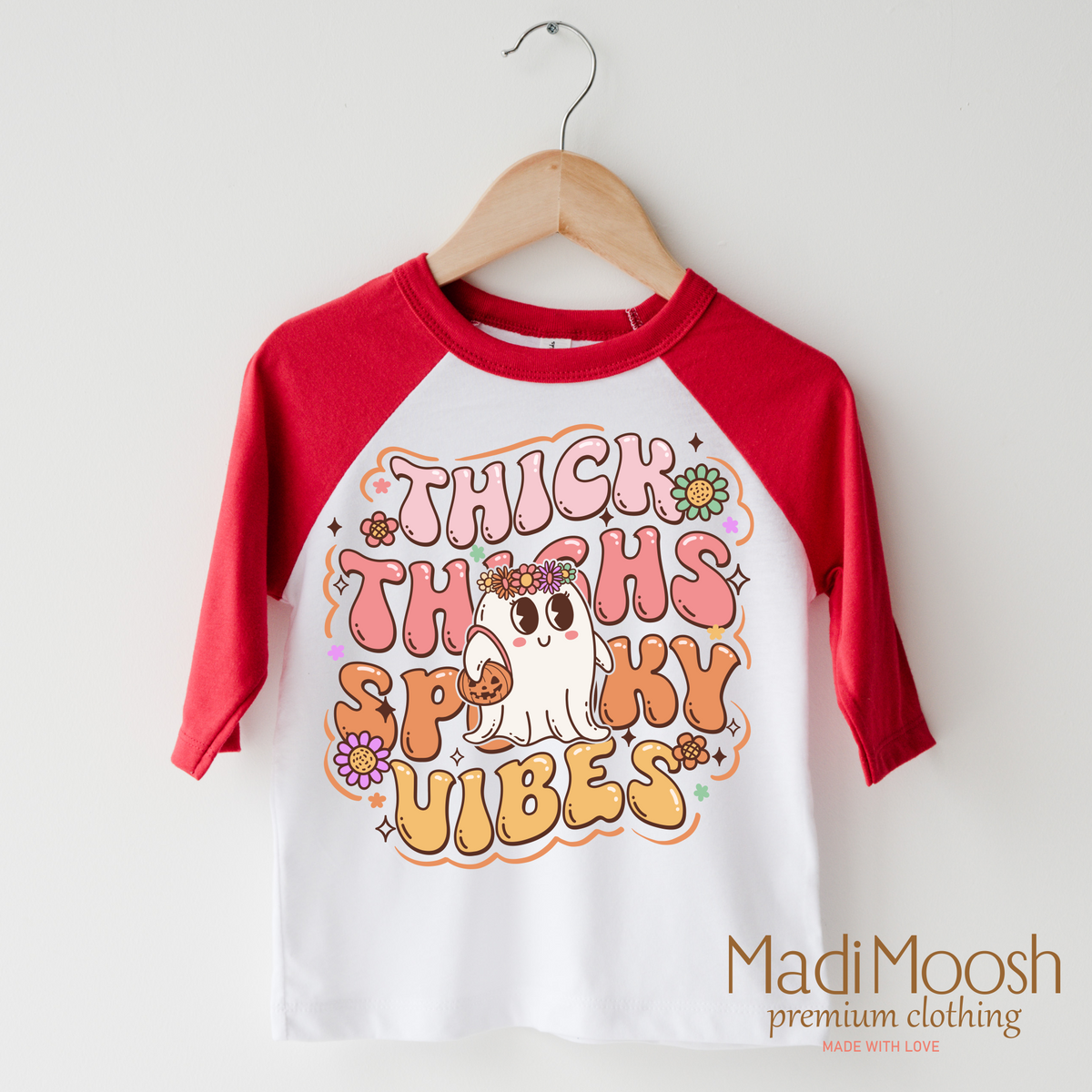 Think Thighs And Spooky Vibes design on a raglan shirt with red sleeves.