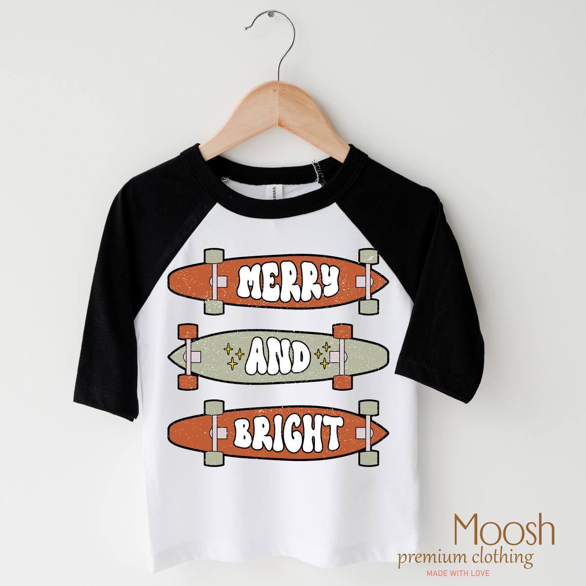 Merry And Bright Skater Christmas design on a raglan shirt with black sleeves.