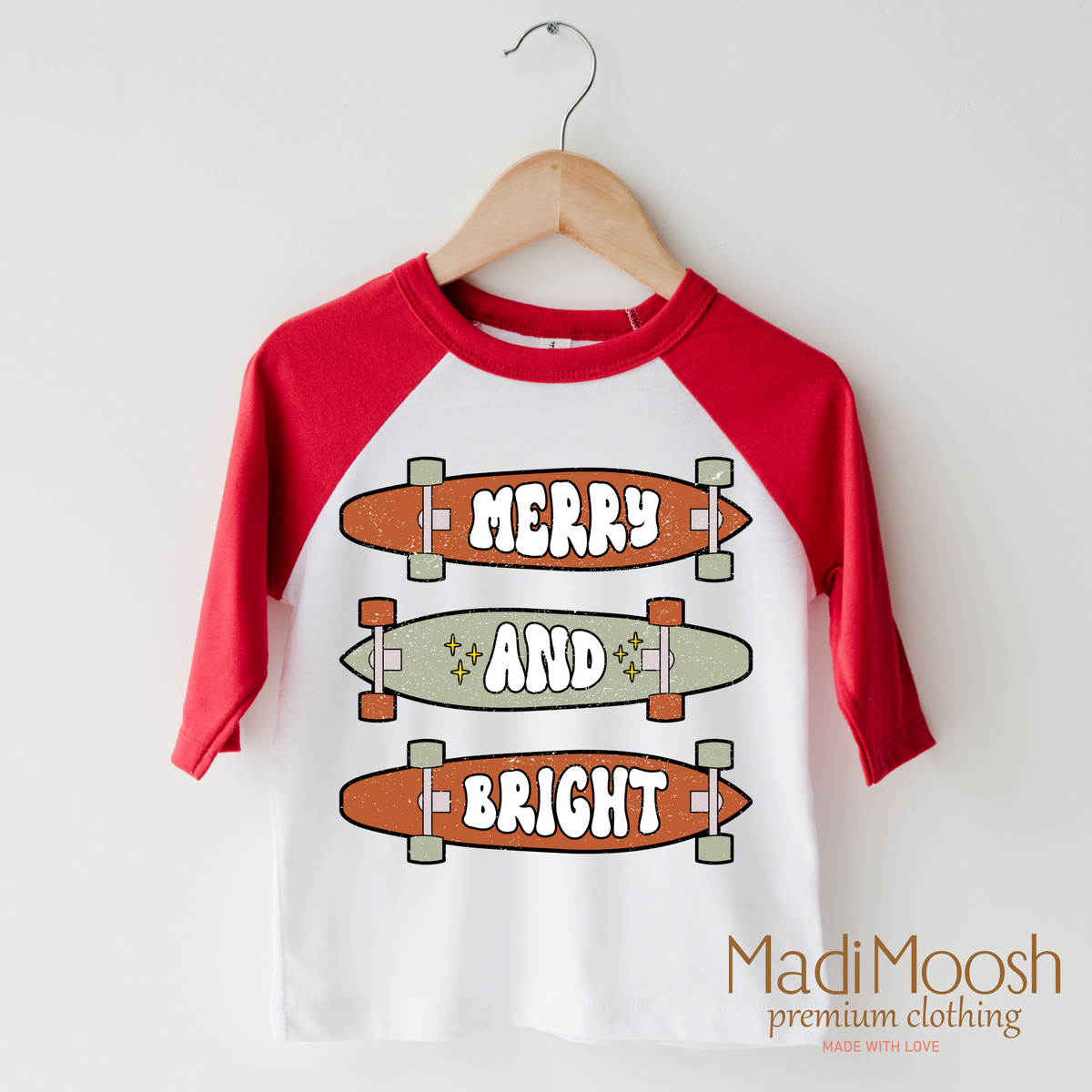 Merry And Bright Skater Christmas design on a raglan shirt with red sleeves.
