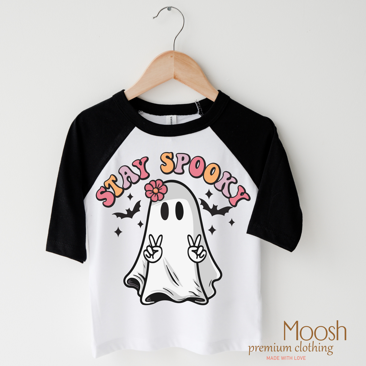 Stay Spooky design on a raglan shirt with black sleeves.